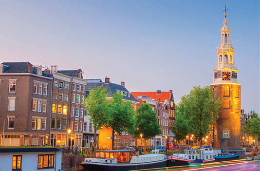 Historic Dutch canal with illuminated clock tower