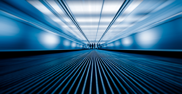 Abstract perspective view of a moving walkway in a modern, blue-toned corridor