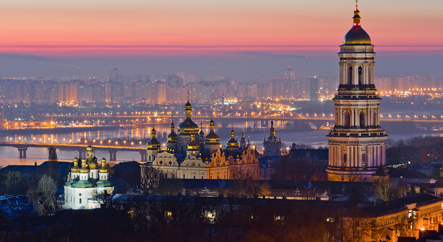 Ukraine cityscape at dusk with lights from city shining across landscape